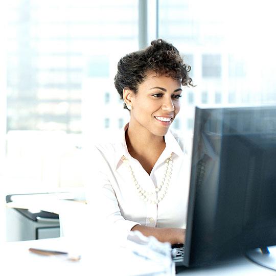 Woman sitting in front of monitor