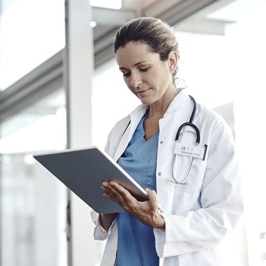 Female doctor looking at laptop